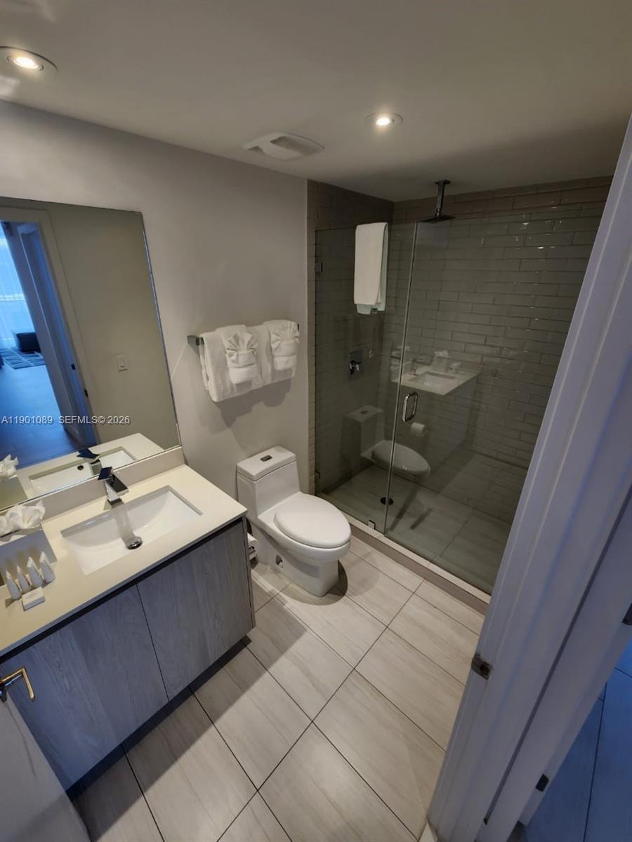 4010 South Ocean Drive, Unit R1709 Hollywood, FL 33019 - Photo 10 of 16 a bathroom with a double vanity sink toilet mirror and shower