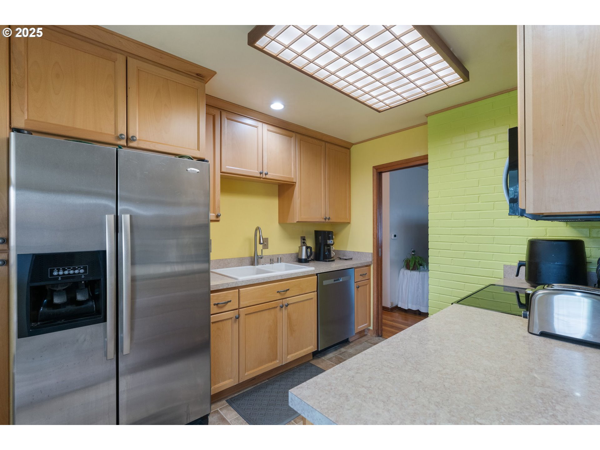 2707 Northeast 123rd Avenue Portland, OR 97230 - Photo 12 of 25 a kitchen with stainless steel appliances kitchen island granite countertop a refrigerator and a sink