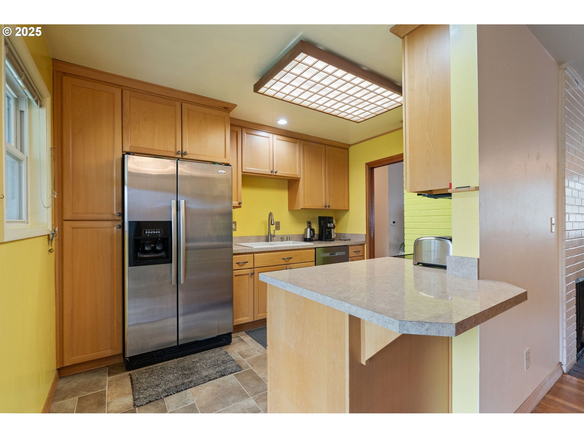 2707 Northeast 123rd Avenue Portland, OR 97230 - Photo 13 of 25 a kitchen with refrigerator cabinets and wooden floor