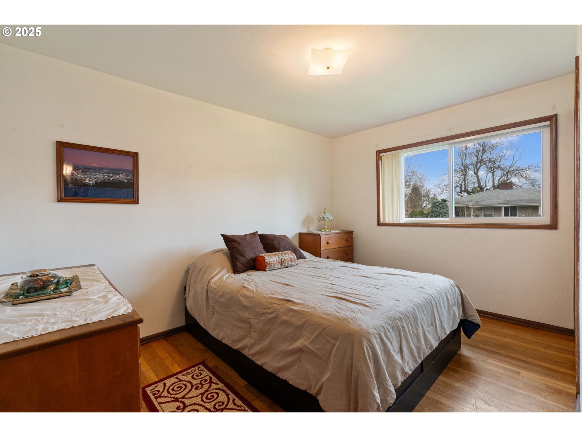2707 Northeast 123rd Avenue Portland, OR 97230 - Photo 14 of 25 a bedroom with a bed and a painting on the wall