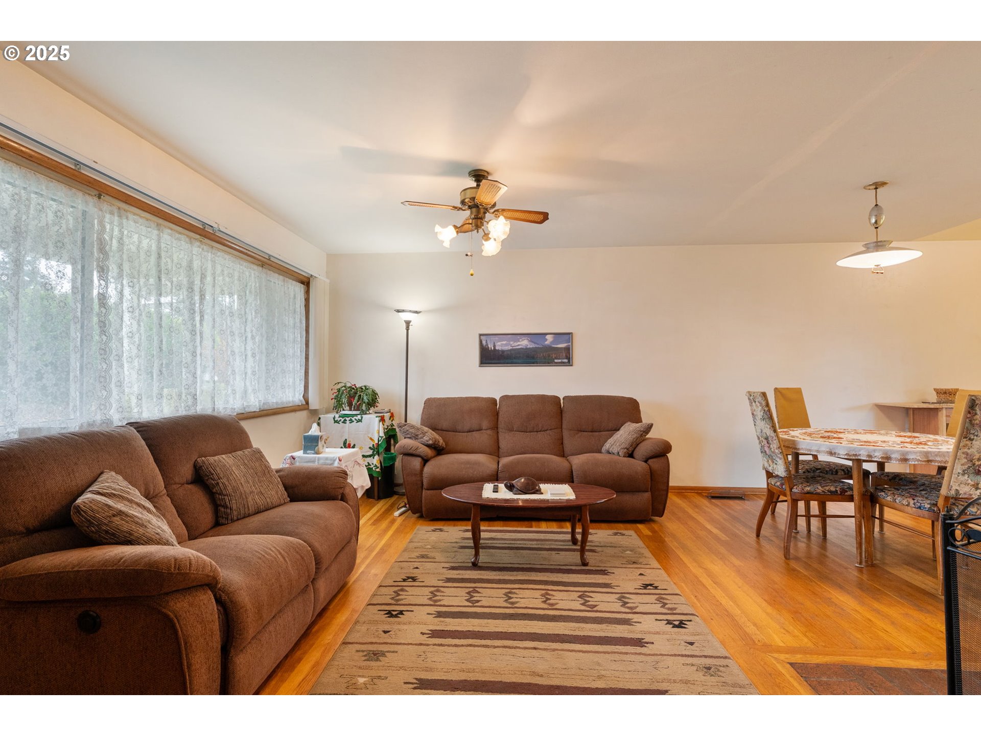 2707 Northeast 123rd Avenue Portland, OR 97230 - Photo 3 of 25 a living room with furniture a chandelier and a dining table with wooden floor
