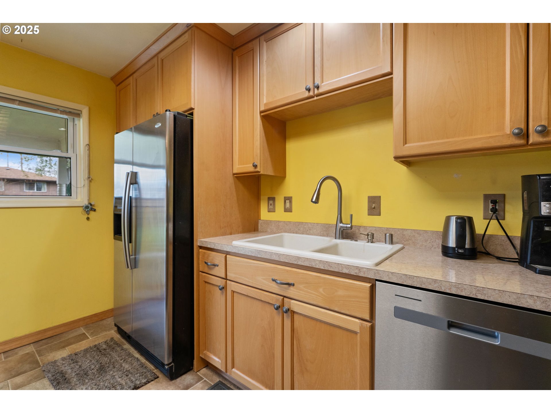 2707 Northeast 123rd Avenue Portland, OR 97230 - Photo 10 of 25 a kitchen with stainless steel appliances granite countertop a sink refrigerator and cabinets