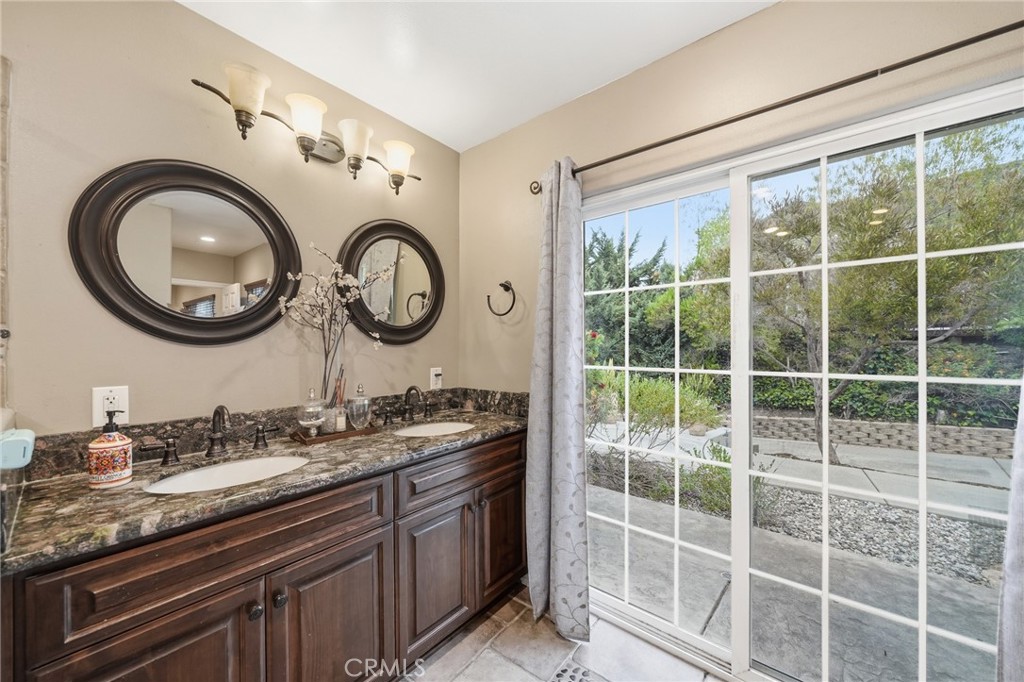 706 Nancy Lane Fullerton, CA 92831 - Photo 13 of 56 a bathroom with a granite countertop double vanity and a large mirror