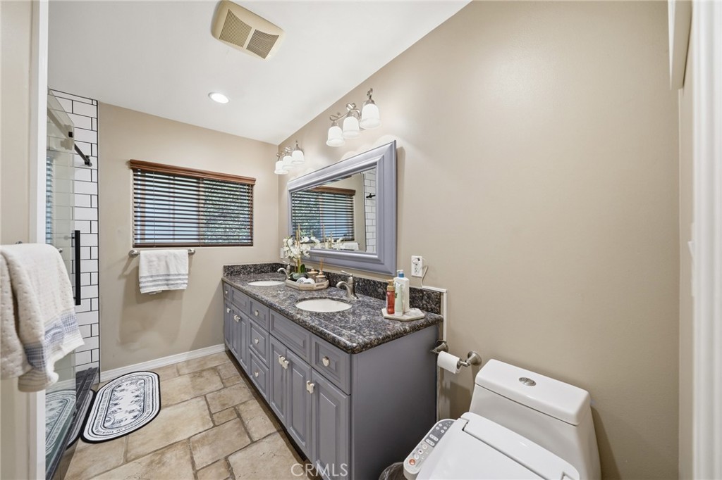 706 Nancy Lane Fullerton, CA 92831 - Photo 14 of 56 a bathroom with a granite countertop toilet sink and mirror