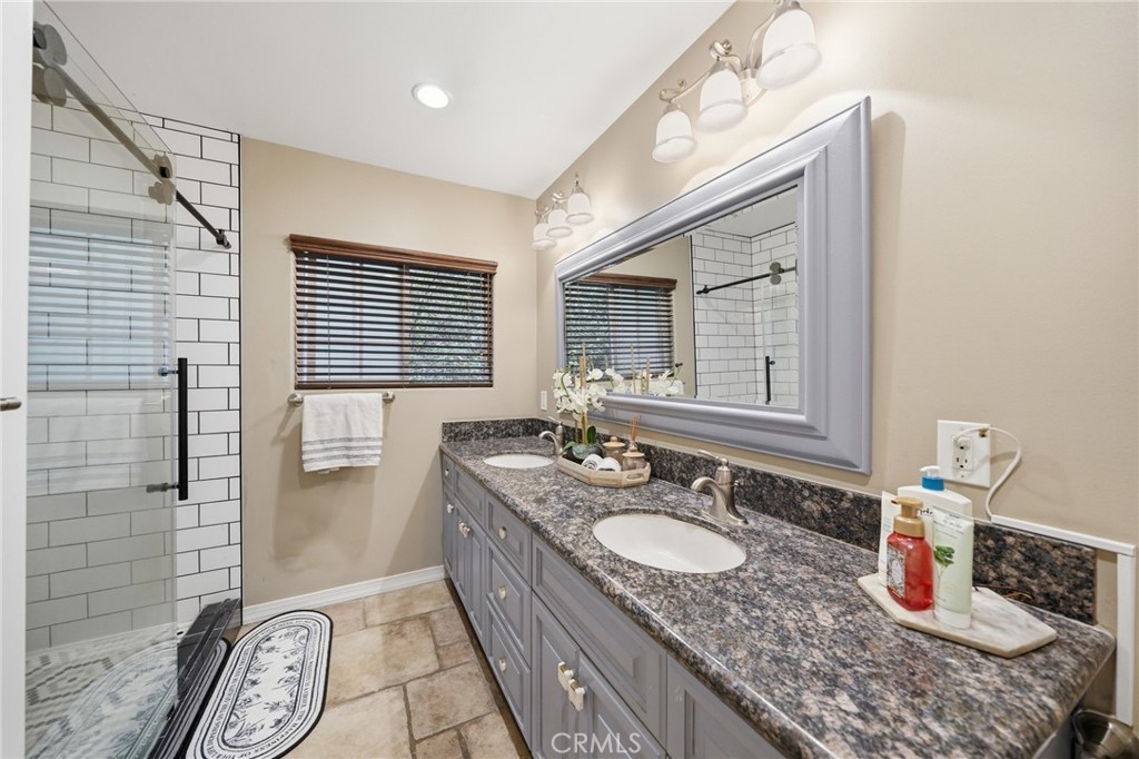706 Nancy Lane Fullerton, CA 92831 - Photo 15 of 56 a bathroom with a granite countertop sink a mirror and shower