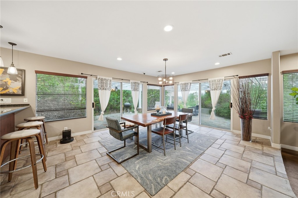706 Nancy Lane Fullerton, CA 92831 - Photo 25 of 56 a view of a dining room with furniture large windows and wooden floor