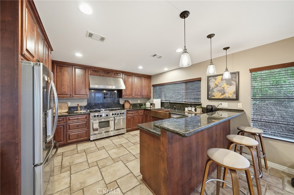 706 Nancy Lane Fullerton, CA 92831 - Photo 31 of 56 a kitchen with stainless steel appliances granite countertop a sink stove and refrigerator