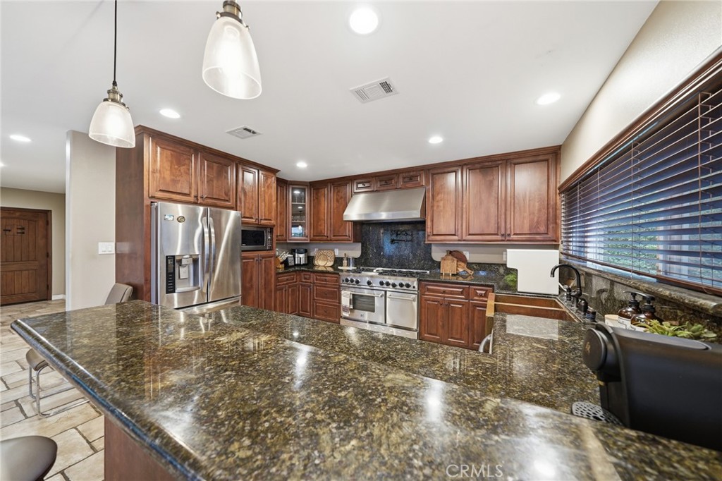 706 Nancy Lane Fullerton, CA 92831 - Photo 32 of 56 a kitchen with stainless steel appliances granite countertop a sink refrigerator and cabinets