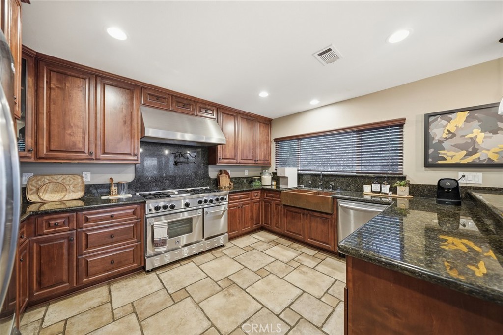 706 Nancy Lane Fullerton, CA 92831 - Photo 33 of 56 a kitchen with stainless steel appliances granite countertop a stove sink and cabinets