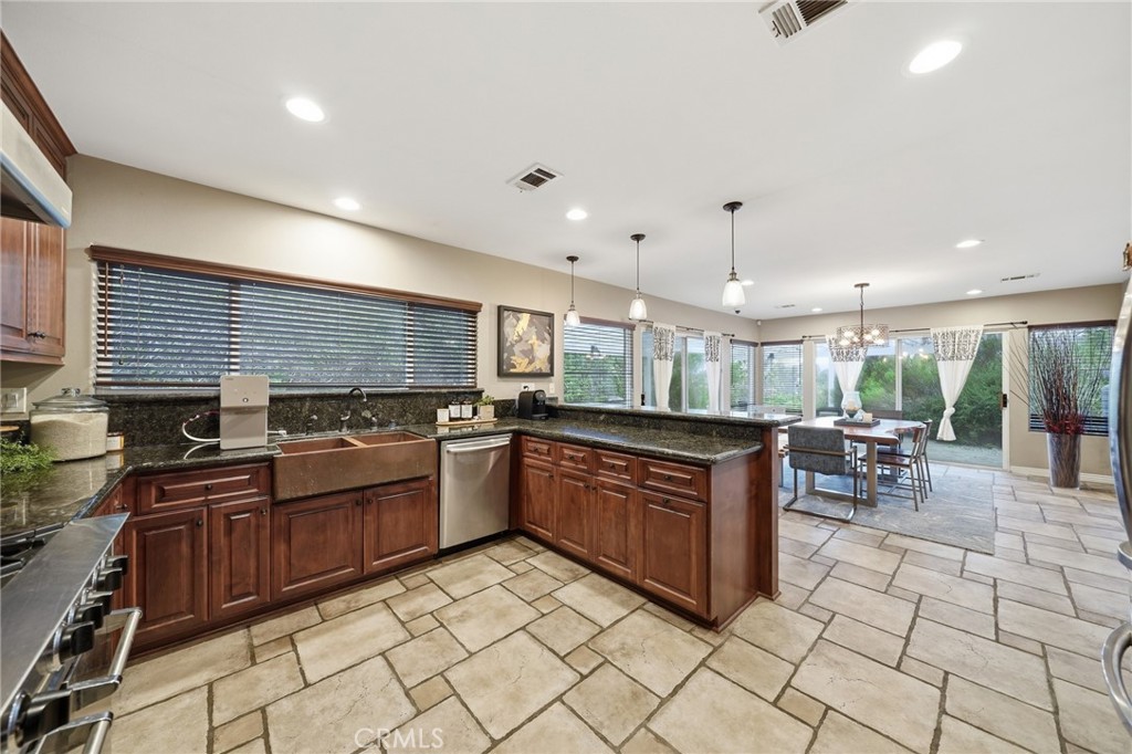 706 Nancy Lane Fullerton, CA 92831 - Photo 34 of 56 a kitchen with stainless steel appliances granite countertop table chairs sink and cabinets
