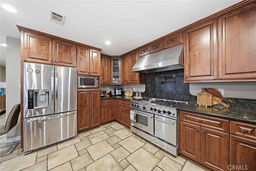 706 Nancy Lane Fullerton, CA 92831 - Photo 35 of 56 a kitchen with granite countertop a refrigerator stove top oven and sink