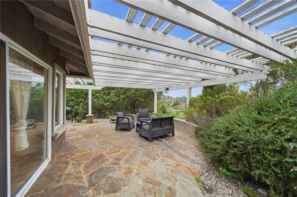 706 Nancy Lane Fullerton, CA 92831 - Photo 36 of 56 a view of a patio with table and chairs potted plants with floor to ceiling window