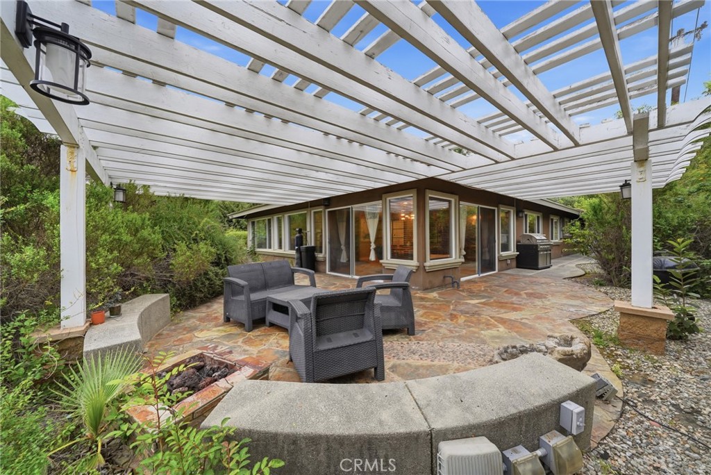 706 Nancy Lane Fullerton, CA 92831 - Photo 38 of 56 a view of a patio with table and chairs potted plants with wooden floor and fence