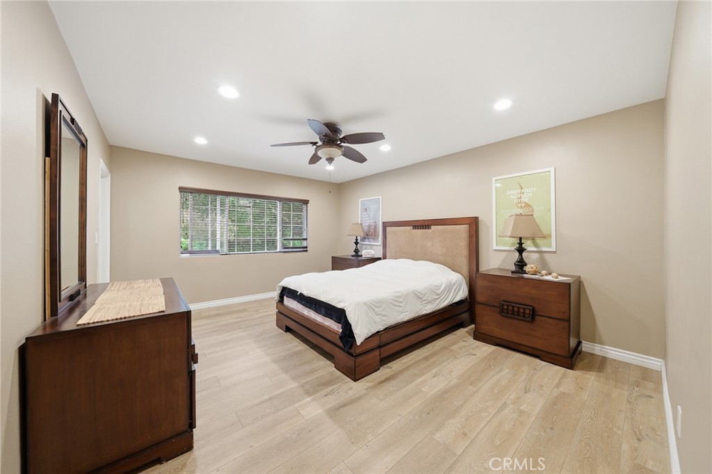 706 Nancy Lane Fullerton, CA 92831 - Photo 10 of 56 a bedroom with a large bed and a chandelier