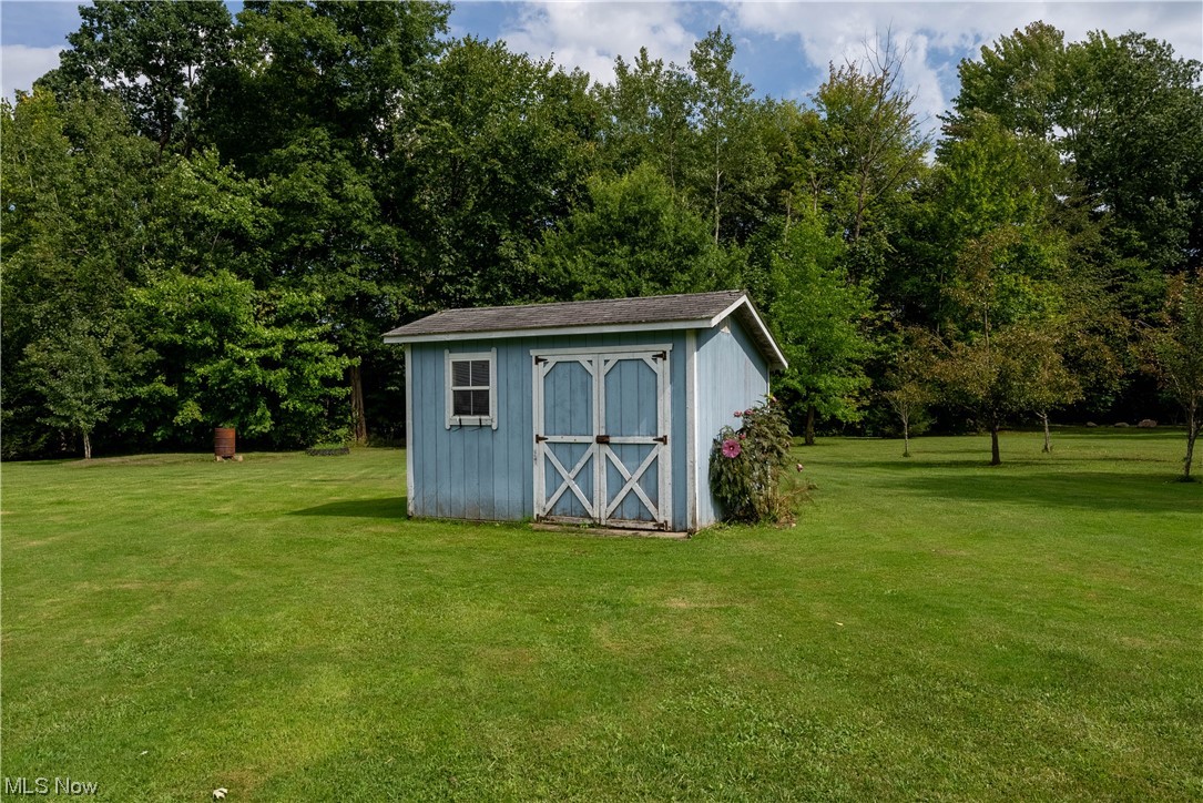 5000 Hoffman Road Rome, OH 44085 - Photo 11 of 34 View of shed / structure featuring a storage unit and a yard