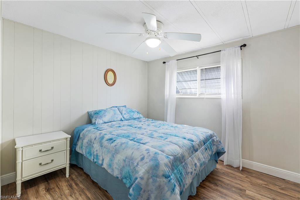 21 Lemans Drive Naples, FL 34112 - Photo 18 of 26 a bedroom with a bed and a window