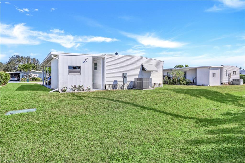 21 Lemans Drive Naples, FL 34112 - Photo 25 of 26 a view of a house with a big yard and large trees