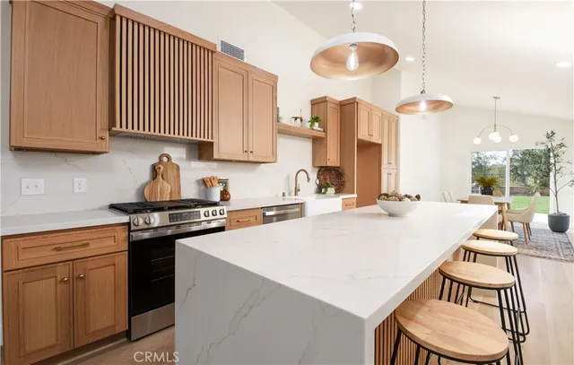 a kitchen with a table chairs stove and cabinets