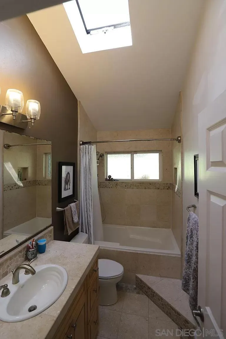2132 Pleasant Grove Road Encinitas, CA 92024 - Photo 14 of 21 a bathroom with a granite countertop sink toilet and shower