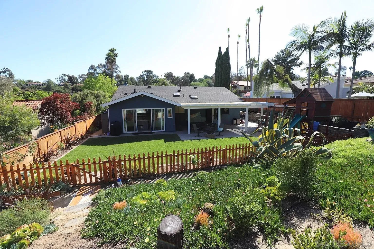 2132 Pleasant Grove Road Encinitas, CA 92024 - Photo 19 of 21 a front view of a house with a garden