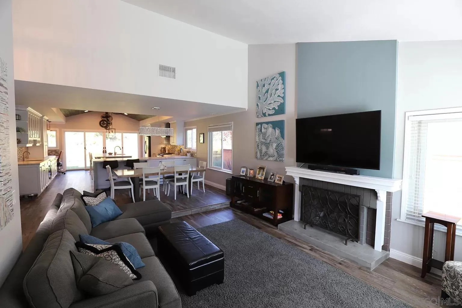 2132 Pleasant Grove Road Encinitas, CA 92024 - Photo 5 of 21 a living room with furniture a flat screen tv and a fireplace