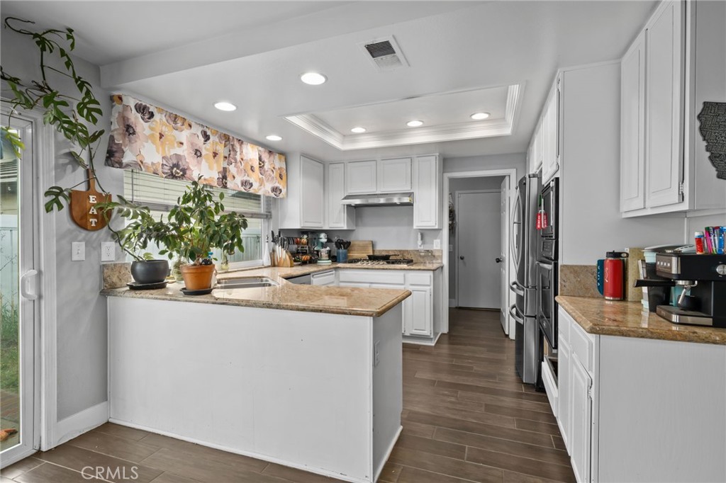5810 Greens Drive Riverside, CA 92509 - Photo 12 of 31 a kitchen with counter top space and living room view