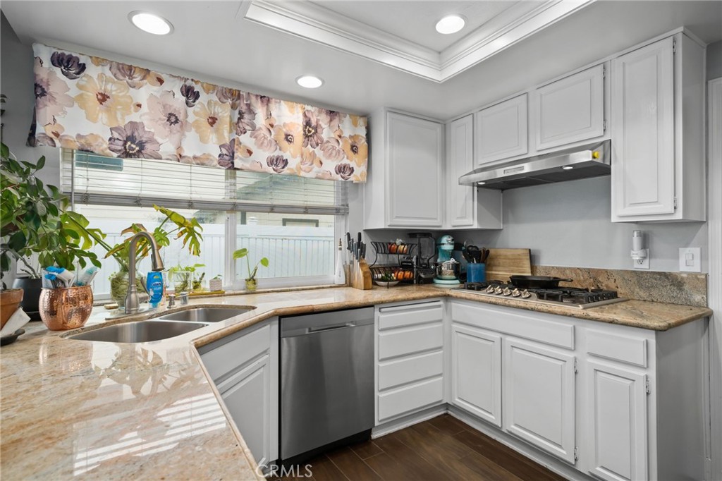 5810 Greens Drive Riverside, CA 92509 - Photo 15 of 31 a kitchen with stainless steel appliances granite countertop a sink a stove and wooden cabinets