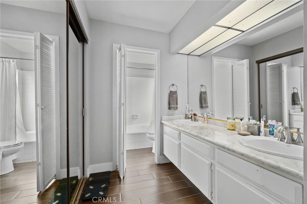 5810 Greens Drive Riverside, CA 92509 - Photo 22 of 31 a spacious bathroom with a double vanity sink a mirror and a bathtub