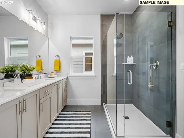 a bathroom with a double vanity sink and a shower
