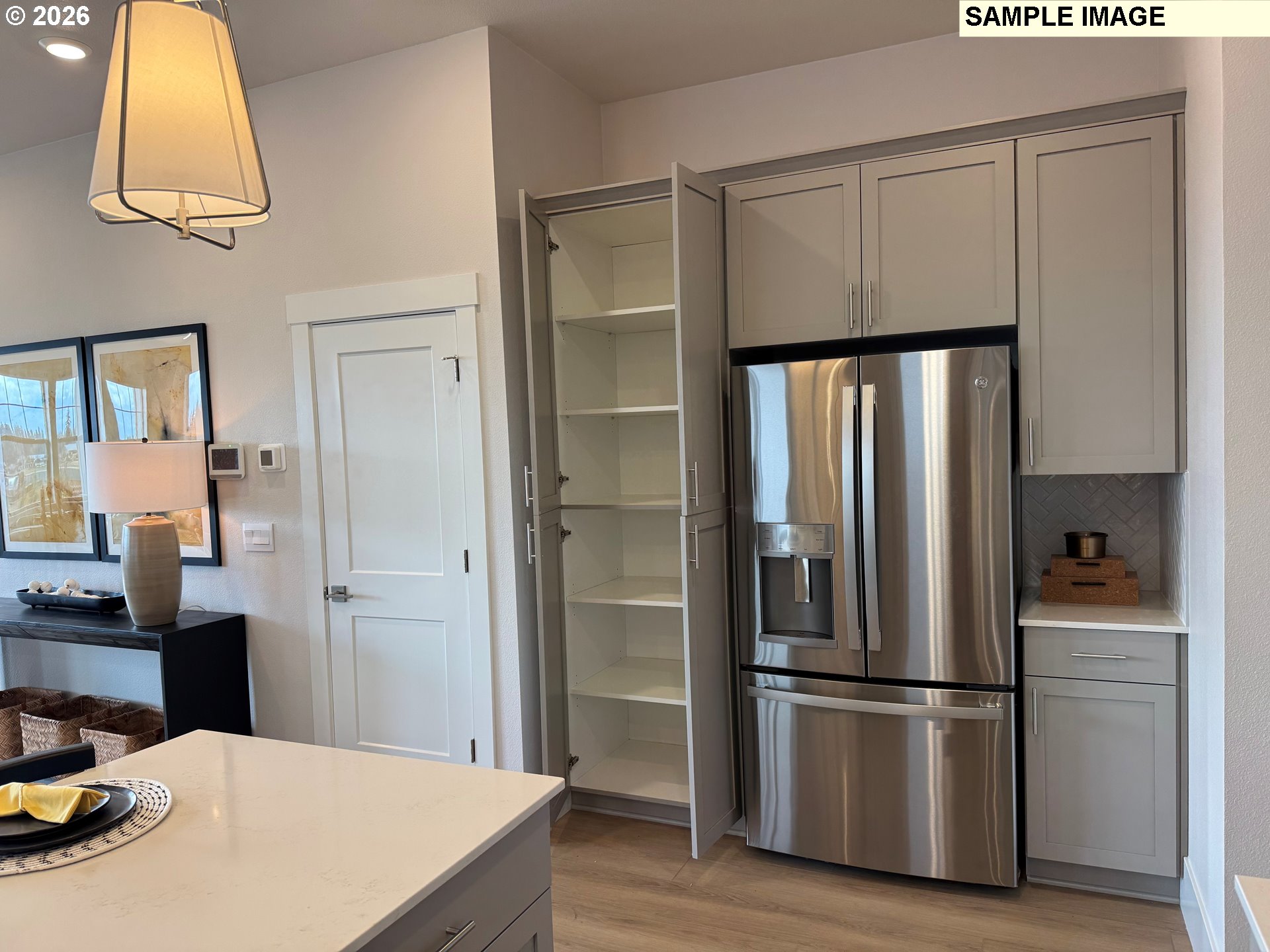 16853 Southwest Pomelo Drive Sherwood, OR 97140 - Photo 14 of 37 a kitchen with kitchen island a counter top space wooden floor and window