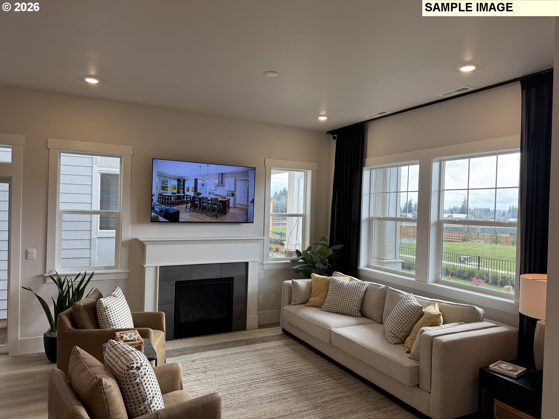 16853 Southwest Pomelo Drive Sherwood, OR 97140 - Photo 2 of 37 a living room with furniture a large window and a fireplace