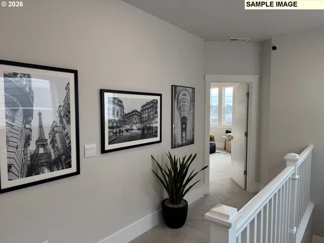 a view of a hallway with paintings on the wall