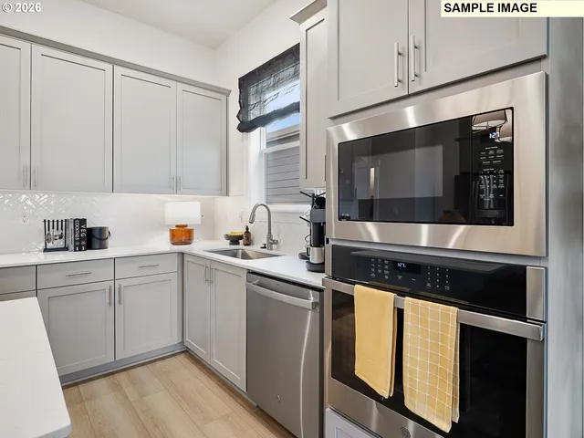 a metallic refrigerator freezer sitting in a kitchen