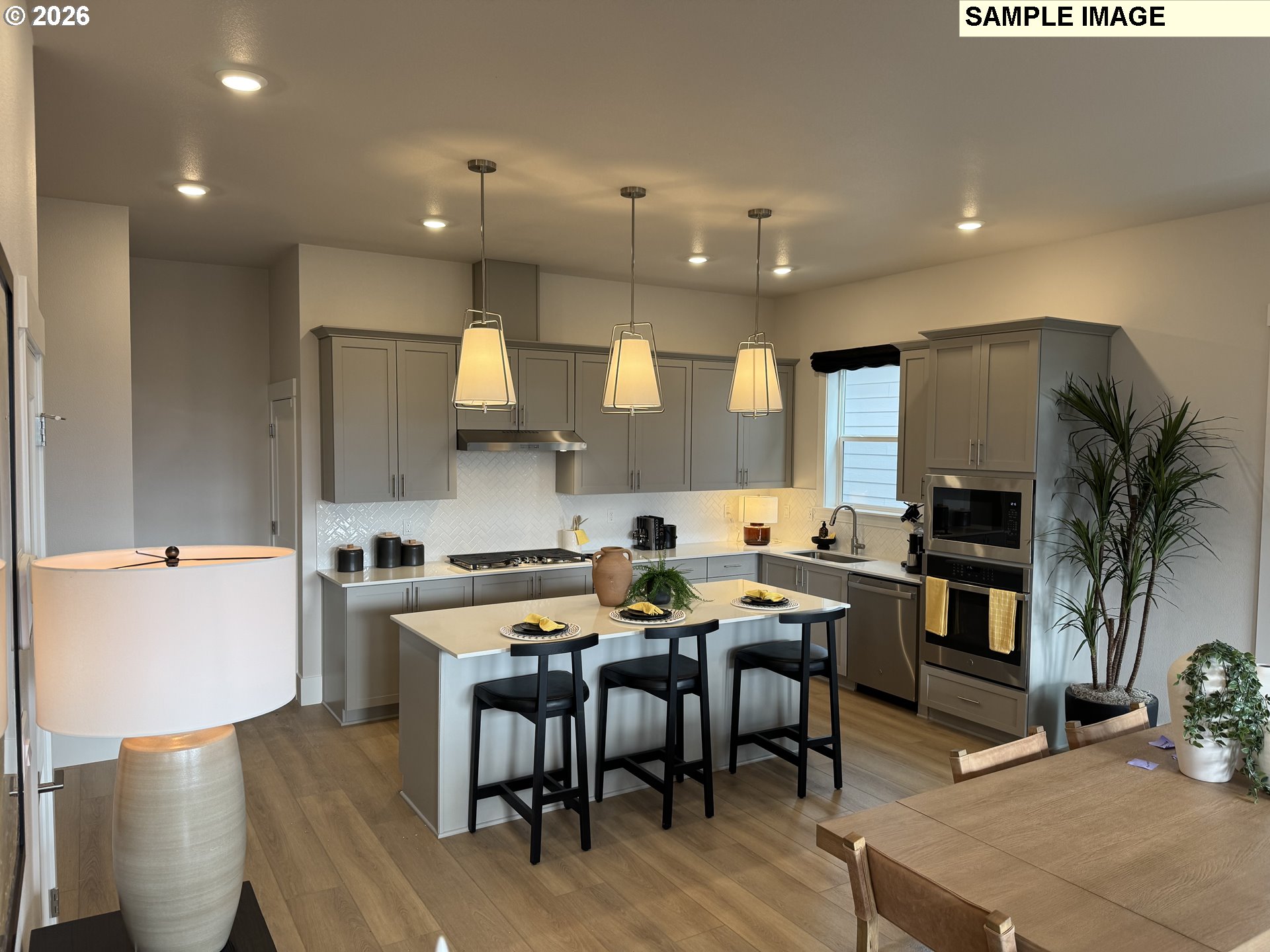 16853 Southwest Pomelo Drive Sherwood, OR 97140 - Photo 4 of 37 a large kitchen with a table and chairs