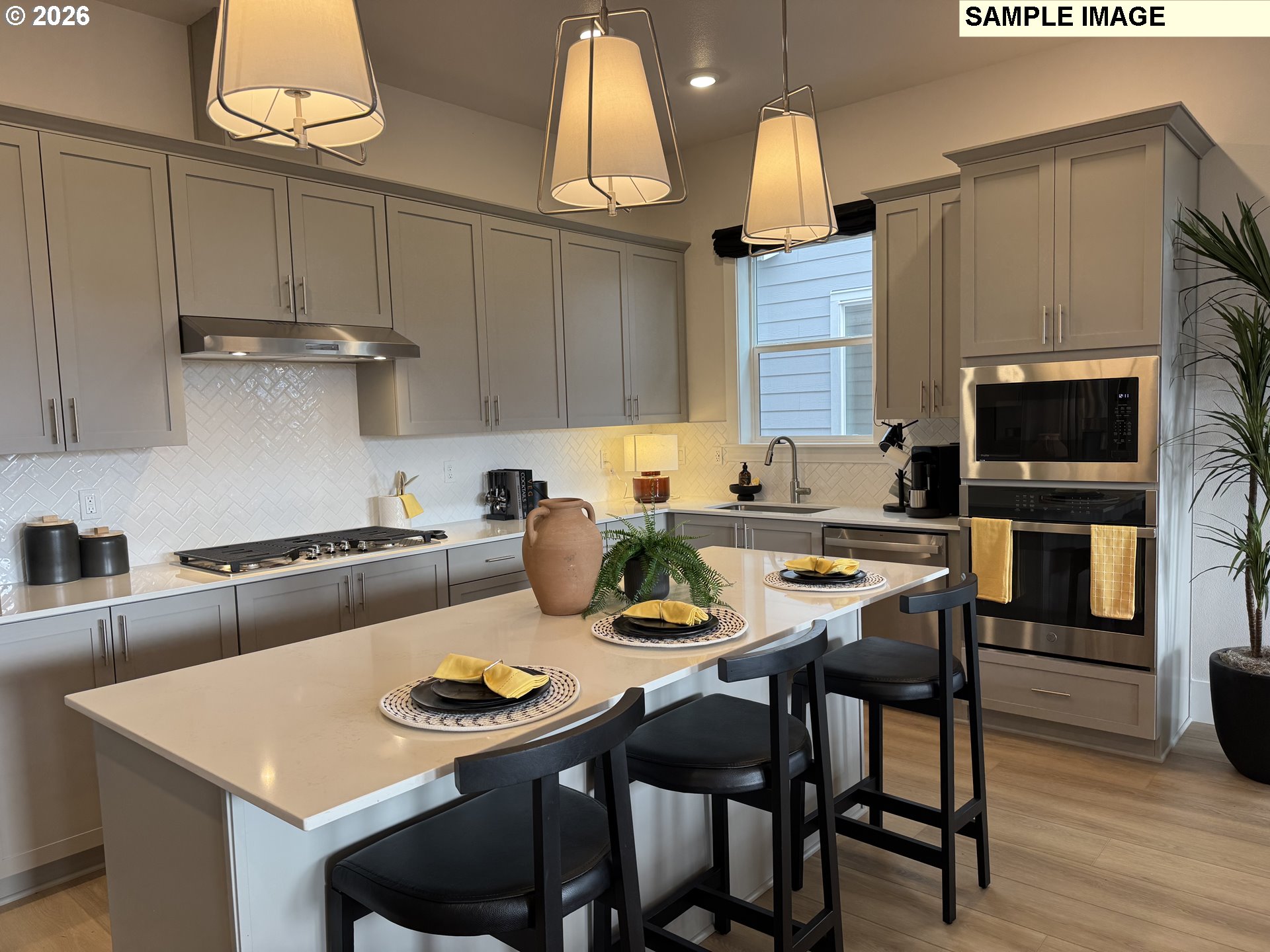 16853 Southwest Pomelo Drive Sherwood, OR 97140 - Photo 5 of 37 a kitchen with a dining table and chairs