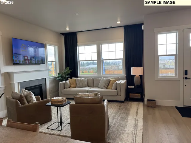 a living room with furniture a large window and a fireplace