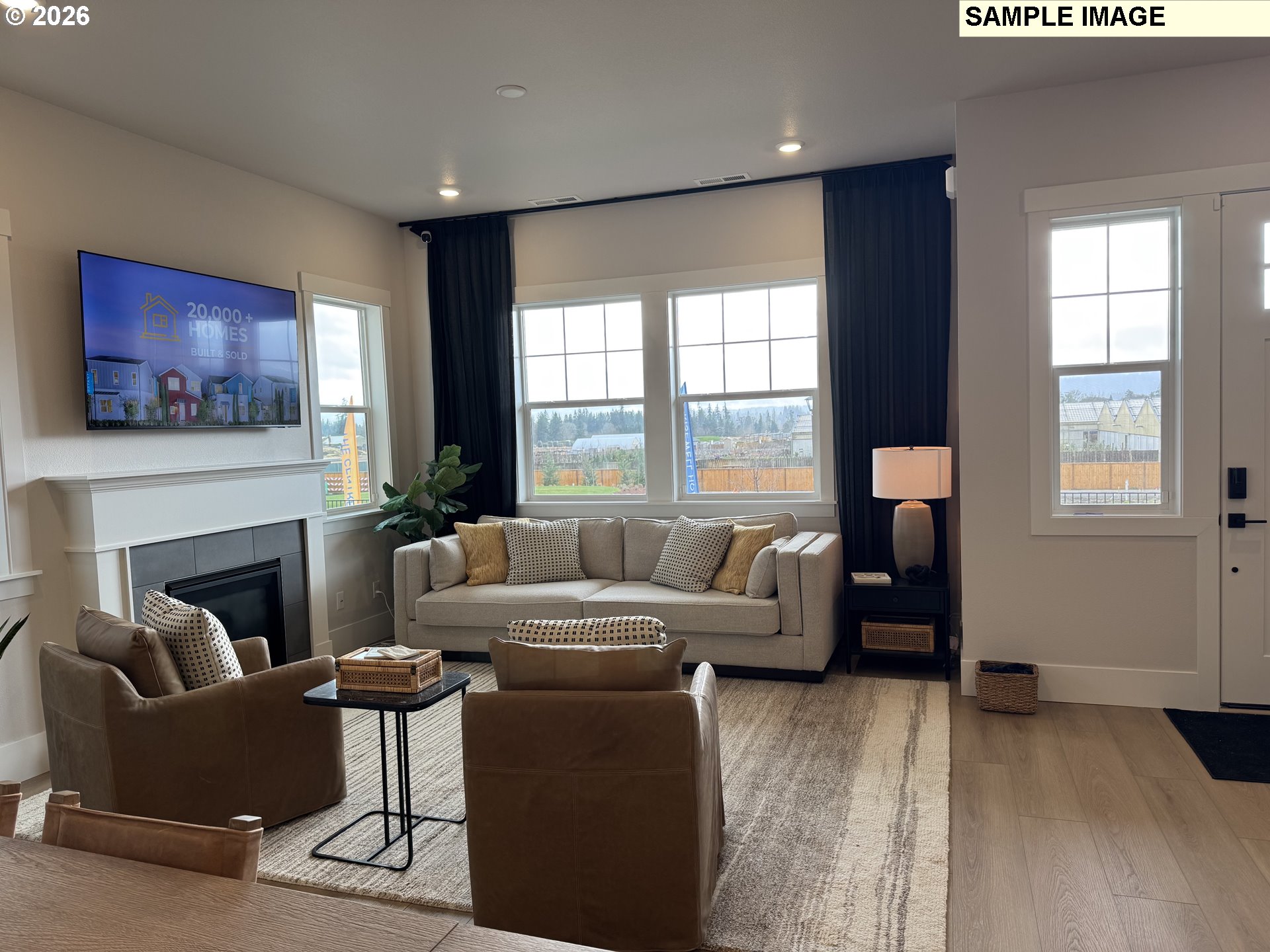 16853 Southwest Pomelo Drive Sherwood, OR 97140 - Photo 6 of 37 a living room with furniture a large window and a fireplace