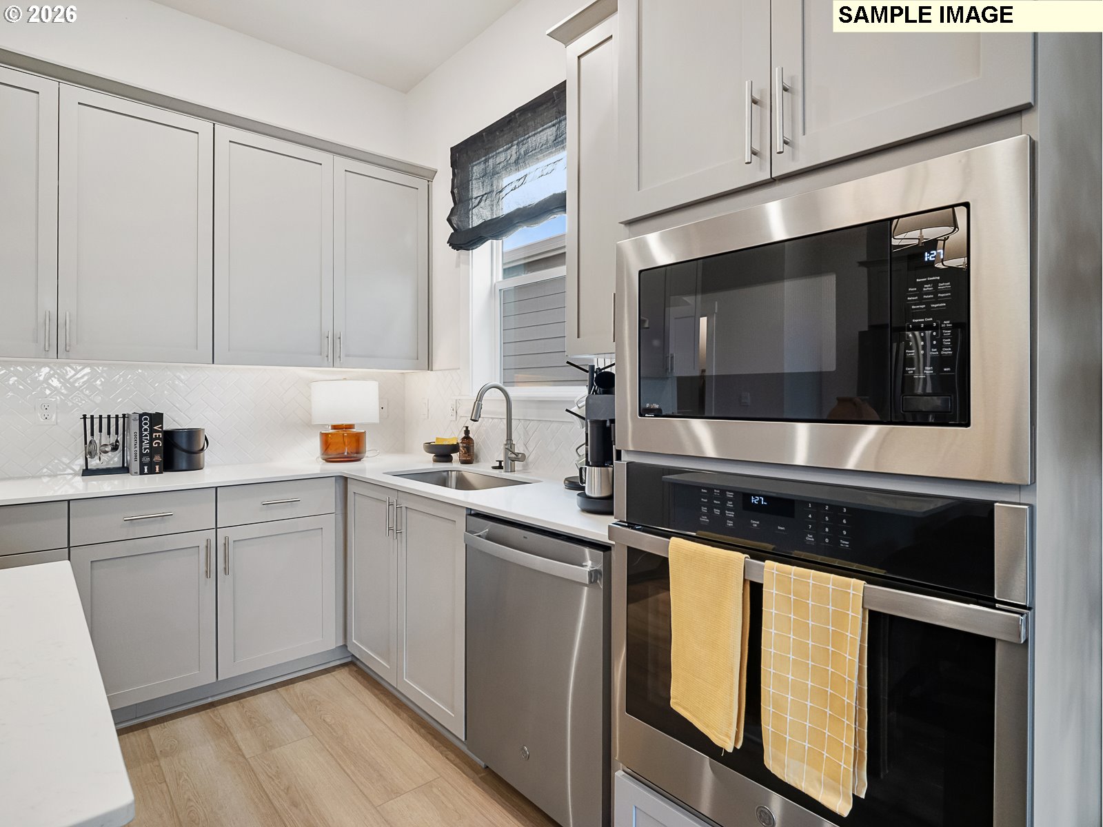 16853 Southwest Pomelo Drive Sherwood, OR 97140 - Photo 8 of 37 a kitchen with stainless steel appliances a sink stove and cabinets