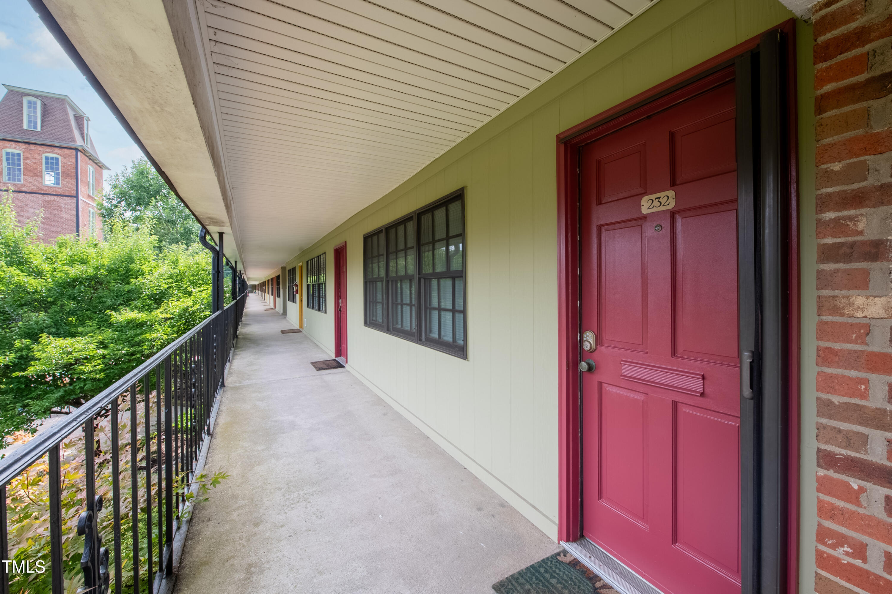 807 West Trinity Avenue, Unit 232 Durham, NC 27701 - Photo 2 of 26 a view of a house with stairs and wooden fence