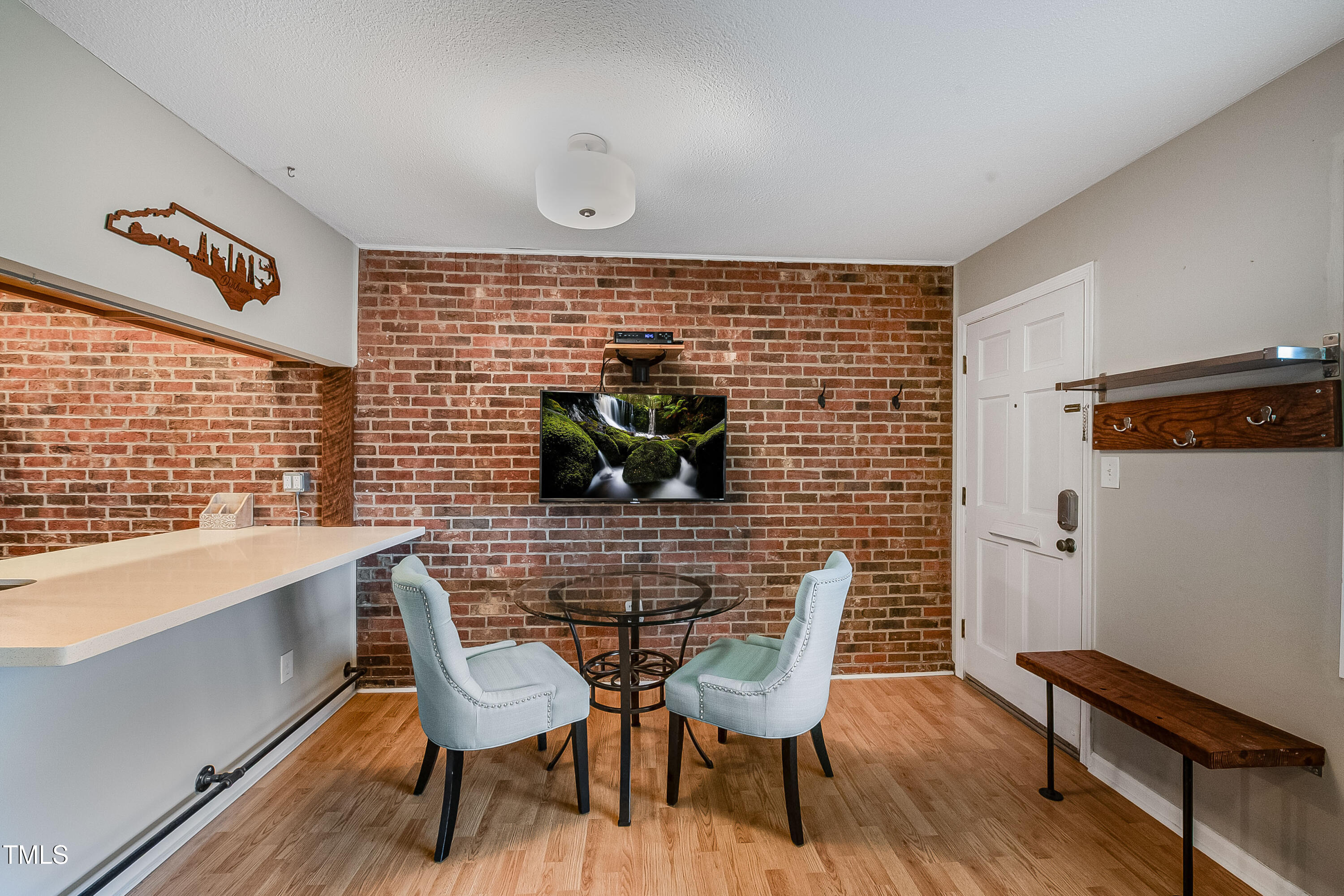 807 West Trinity Avenue, Unit 232 Durham, NC 27701 - Photo 5 of 26 a view of a dining room with furniture and wooden floor