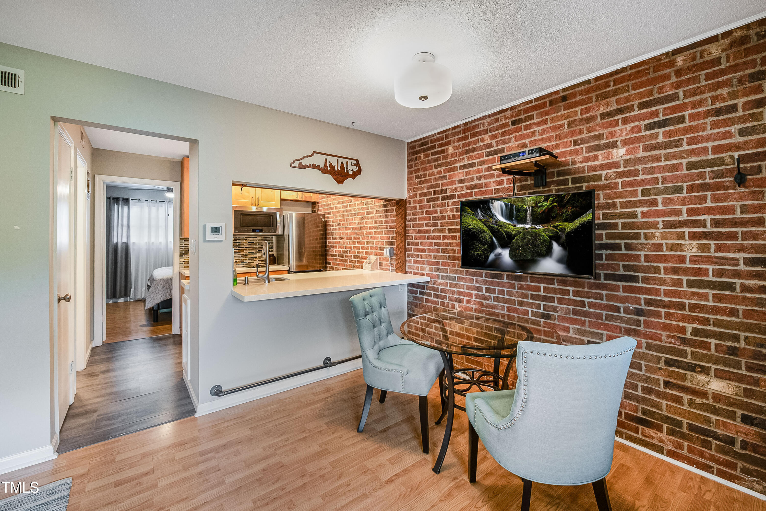 807 West Trinity Avenue, Unit 232 Durham, NC 27701 - Photo 6 of 26 a view of a dining room with furniture and wooden floor