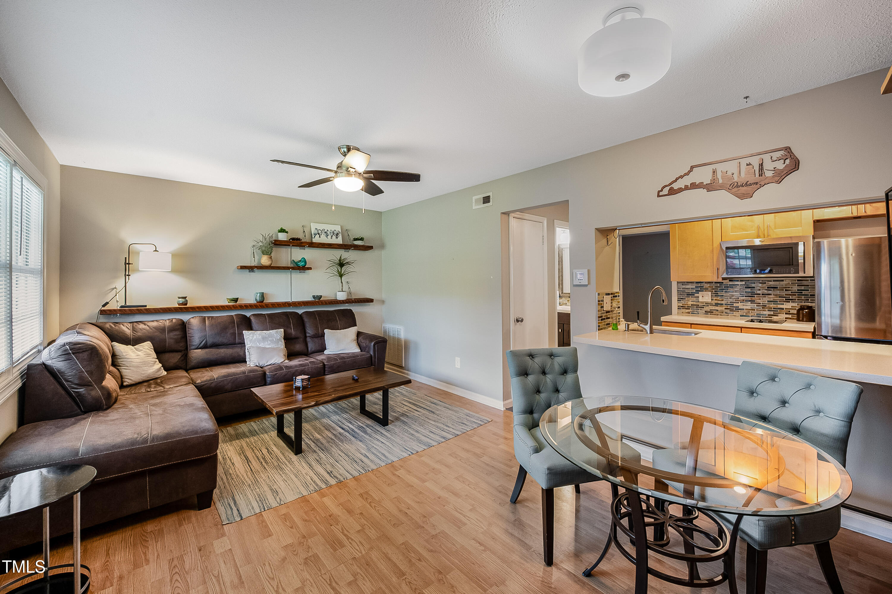 807 West Trinity Avenue, Unit 232 Durham, NC 27701 - Photo 7 of 26 a living room with furniture a chandelier and a wooden floor