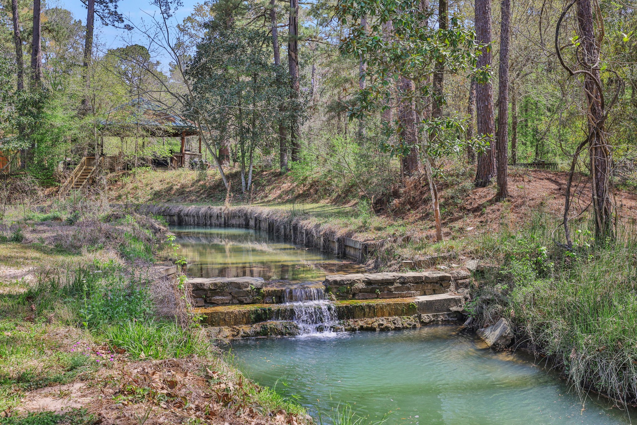 250 Critter Creek Road Coldspring, TX 77331 - Photo 4 of 48 Critter Creek flows through the property - there is an area that has bulkhead and bulkhead close to the main home