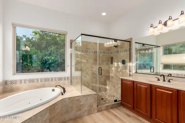 a bathroom with a large tub a sink and a shower