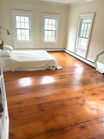 a view of a room with wooden floor and window