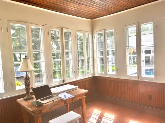 a living room with a large window and a table