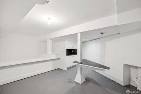 an aerial view of residential houses with outdoor space and ocean view