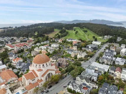a dining room with furniture a wall painting and a table