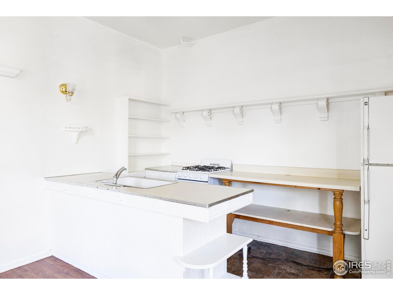 1843 Grove Street Boulder, CO 80302 - Photo 11 of 16 a kitchen with a sink a stove and a refrigerator