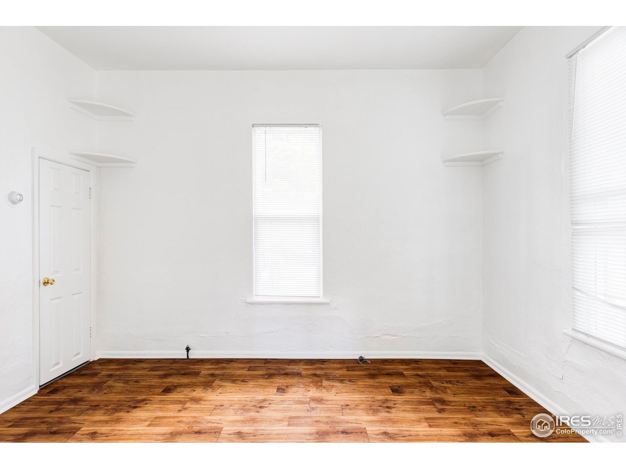 1843 Grove Street Boulder, CO 80302 - Photo 13 of 16 a view of an empty room with window and wooden floor